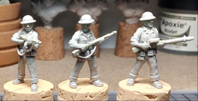 28mm miniature set titled 'Yangtze Patrol' by BrigadeGamesMinis.com, showing three unpainted USN sailor miniatures with helmets armed with tommy gun, BAR and lewis gun on a worktable