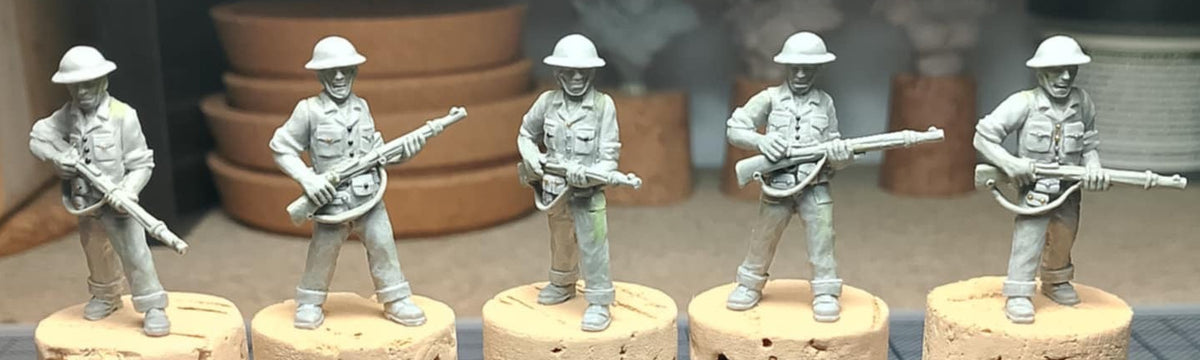 image for BrigadeGamesMinis 'Yangtze Patrol' 28mm miniatures, showing unpainted USN Sailor D figures with helmets and rifles on a work table